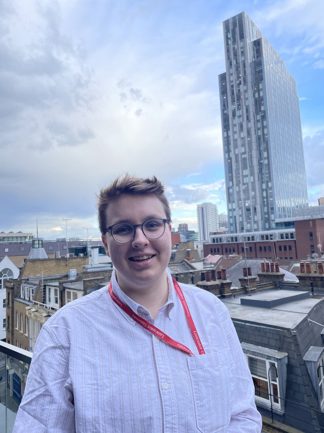 Amelia Foster standing in front of the London skyline.
