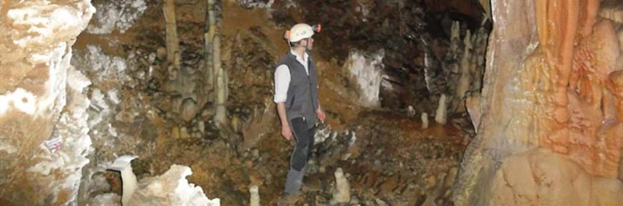 Researchers standing in a cavern