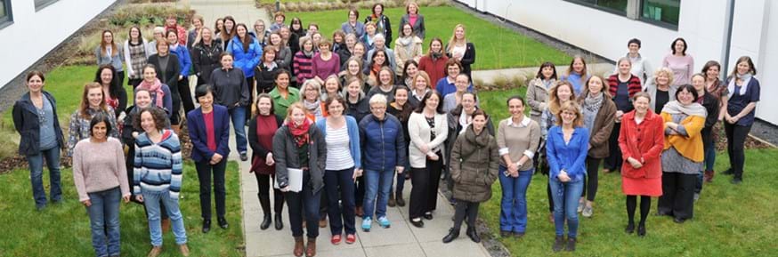 The many women of Lancaster Environment Centre standing together in the gardens outside the building