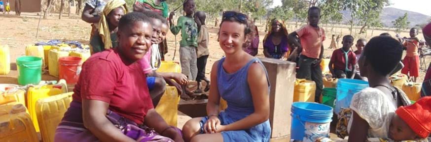 Margherita Lala sitting among residents of Chololo Ecovillage in Tanzania