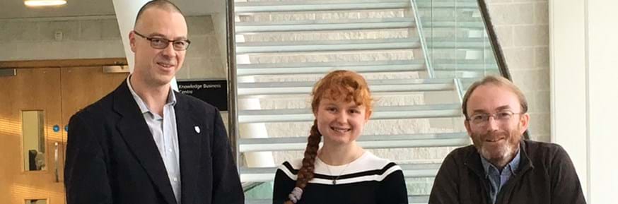 Megan Borland standing proud after winning the Ede & Ravenscroft Women into Science accolade for her department stood next to Professor Adrian Friday and Dr Paul Rayson.