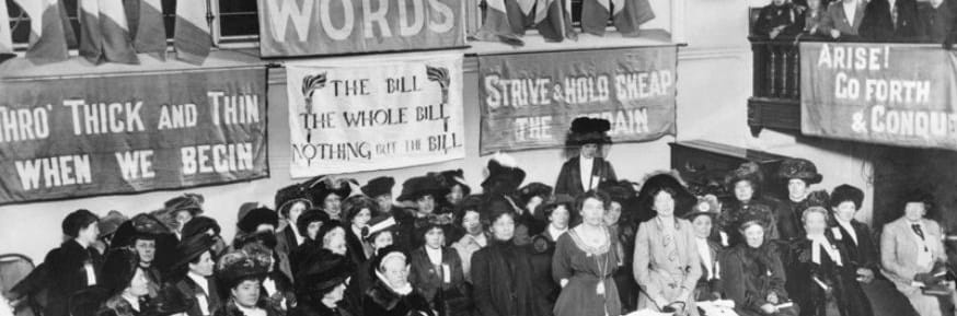 A suffragette meeting in Caxton Hall, Manchester, England circa 1908. Emmeline Pethick-Lawrence and Emmeline Pankhurst stand in the centre of the platform