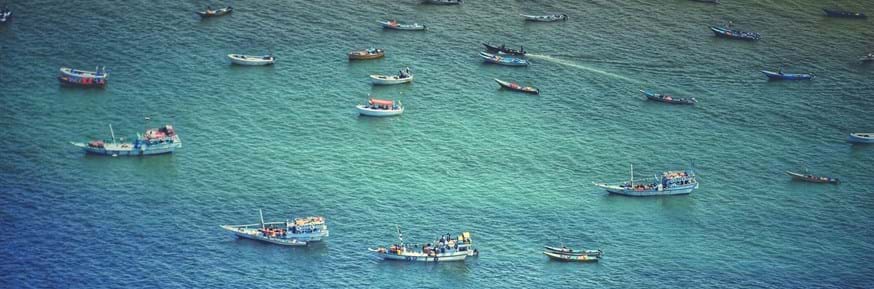 Fishermen leaving port for a long day out at sea fishing - represents this issue of climate change => poverty => overfishing,