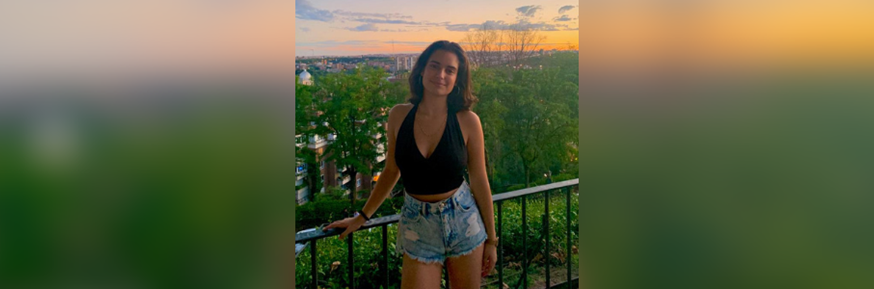 Carmen photographed at a city viewpoint with a sunset