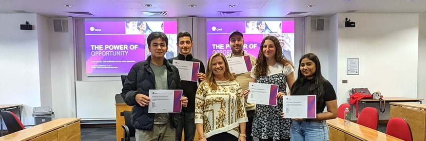 The following people stood with Samantha Mathieson (CIMA), holding certificates in a lecture theatre: Ben Lane, Adit Kaleka, Will Dalton, Bethan Jones and Nidhi Subash