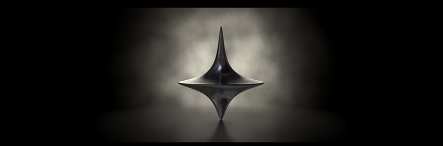 Image shows a spinning top in the dark