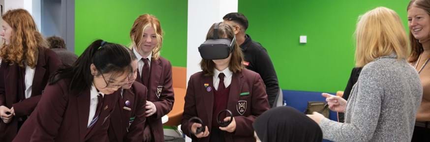 Image of the girls trying out the Virtual Reality headsets