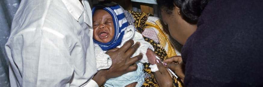 A crying baby getting vaccinated