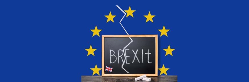 Blackboard showing the word Brexit with a zig zag line cutting through it and set against a European Union flag style blue backdrop with gold stars