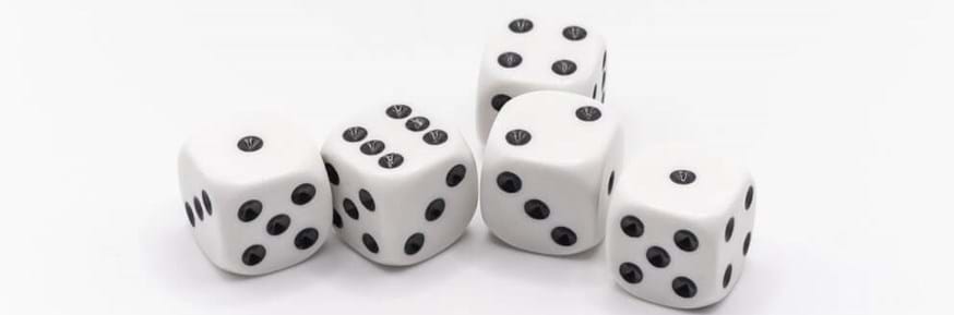 Group of five white dice with black dots.