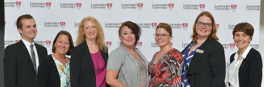Chris Ellison with Lancaster University’s Graduation team L-R: Chris Ellison; Sue Clough; Sarah Wroe; Anna Mackenzie; Manuela Barba; Christine Phillips; Abi Lucy-Lloyd