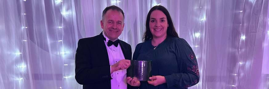 Carbon, Environment & Sustainability Manager Jon Mills on the left of the picture and Marketing and Communications Officer Natalie Bauer on the right, both holding the Money for Good trophy at the 2023 Green Gown Awards.