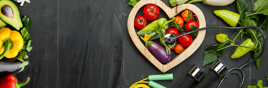 Image of heart shape with a selection of fruit, vegetables and fitness equipment
