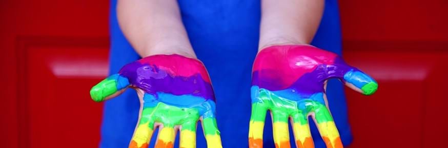 hands with rainbow paint