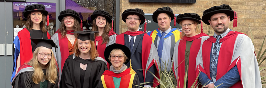 An image of History staff and recent graduates outside the Great Hall