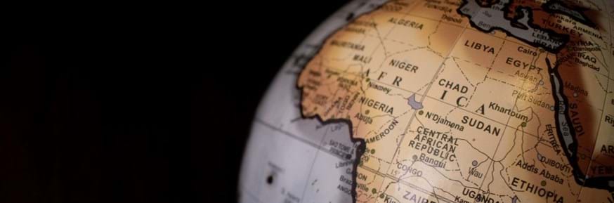 The image shows Africa on a globe against a black backdrop.