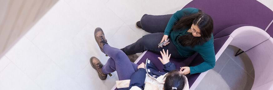 Two female students talking, shot from above
