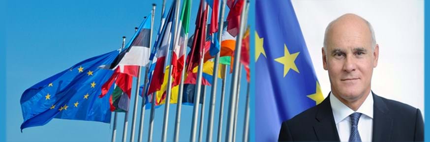 European Union Ambassador to the United Kingdom João Vale de Almeida - background of EU flags