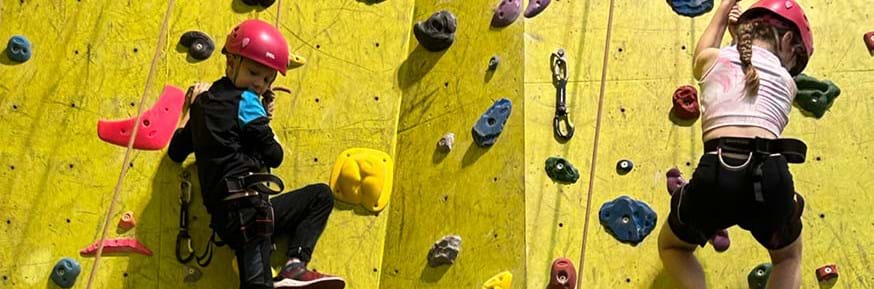 Photo of children on the climbing wall.