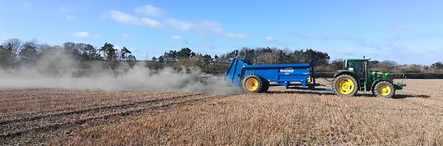 A tractor spreading on a field
