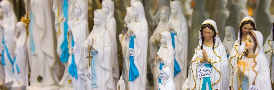 Small statues of Our Lady sold in a souvenir shop in Lourdes