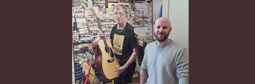 Michael Youds with his shortlisted portrait, 'Labour of Love' which captures Tommy Robertson, the owner of an independent music store in Edinburgh. 
