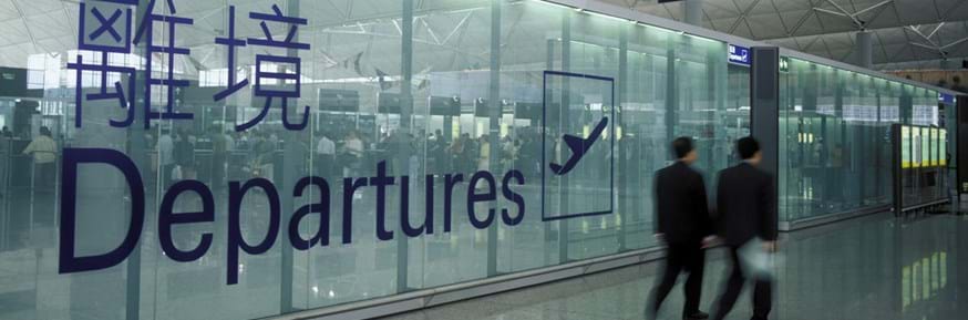 Picture of an airport interior with the Departures sign