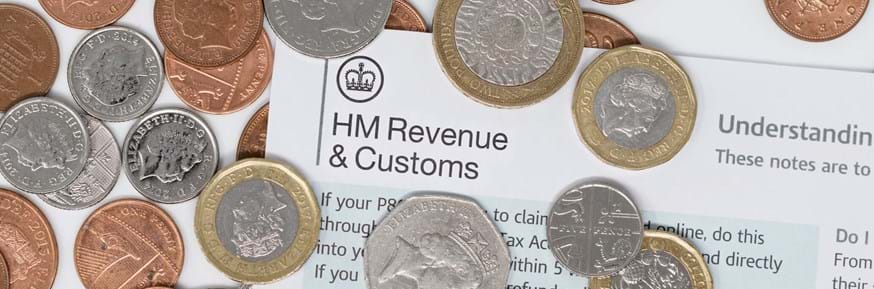 HMRC tax bill surrounded by coins