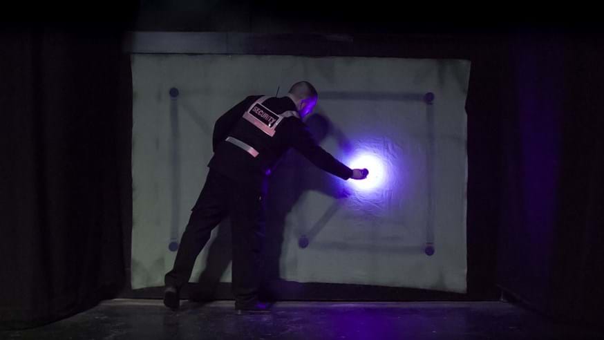A member of the University security team getting to grips with cyanotype - a technique which uses UV light to create stunning images