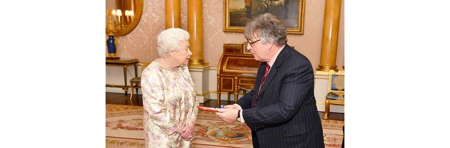 Professor Paul Muldoon receives the Queen's Gold Medal for poetry from Her Majesty the Queen