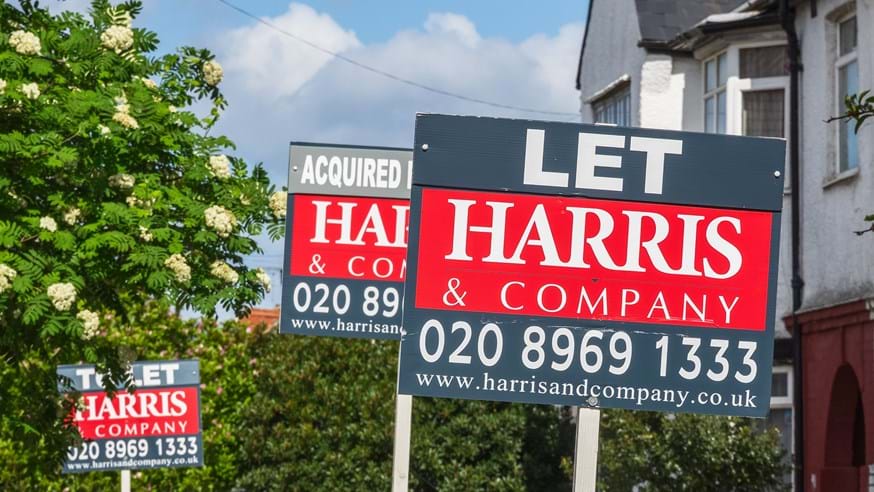 Estate agent signs advertising home for rent or sale.