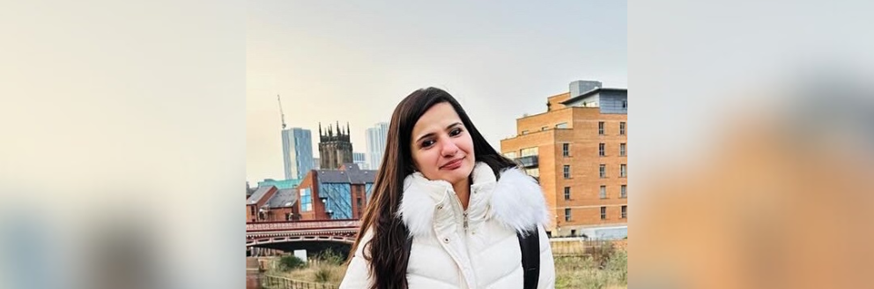 Shivangi photographed at a city view point wearing a padded white coat
