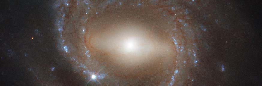 3, imaged by the Hubble Space Telescope's Wide Field Camera 3, is a barred spiral galaxy — like the Milky Way. Older spiral galaxies are more likely to have the bar across their center that's pictured here, suggesting bars indicate a galaxy's maturity.(Image: © ESA/Hubble & NASA, J. Walsh