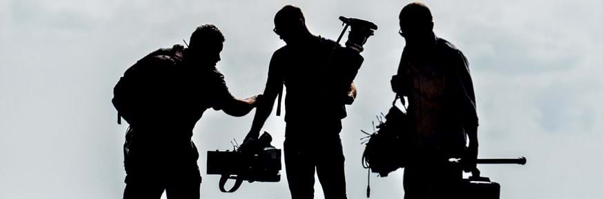 A film crew on a beach