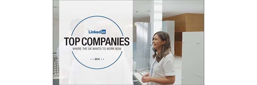 A female student in front of a sign saying: LinkedIn top companies to work with
