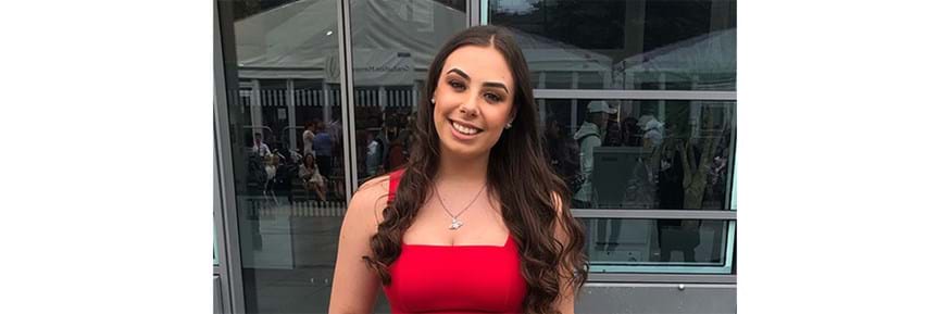 A female student wearing a red dress