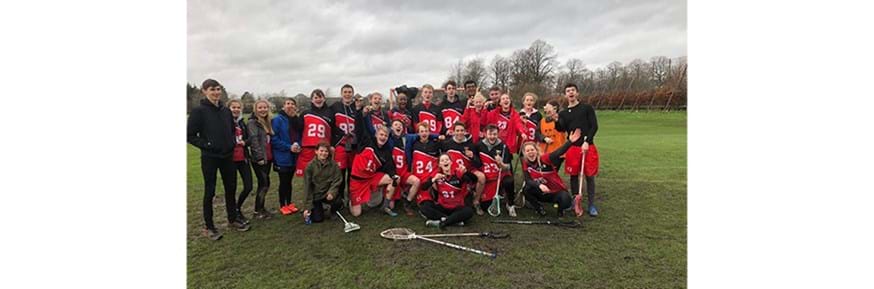 A student lacrosse team on the sports field